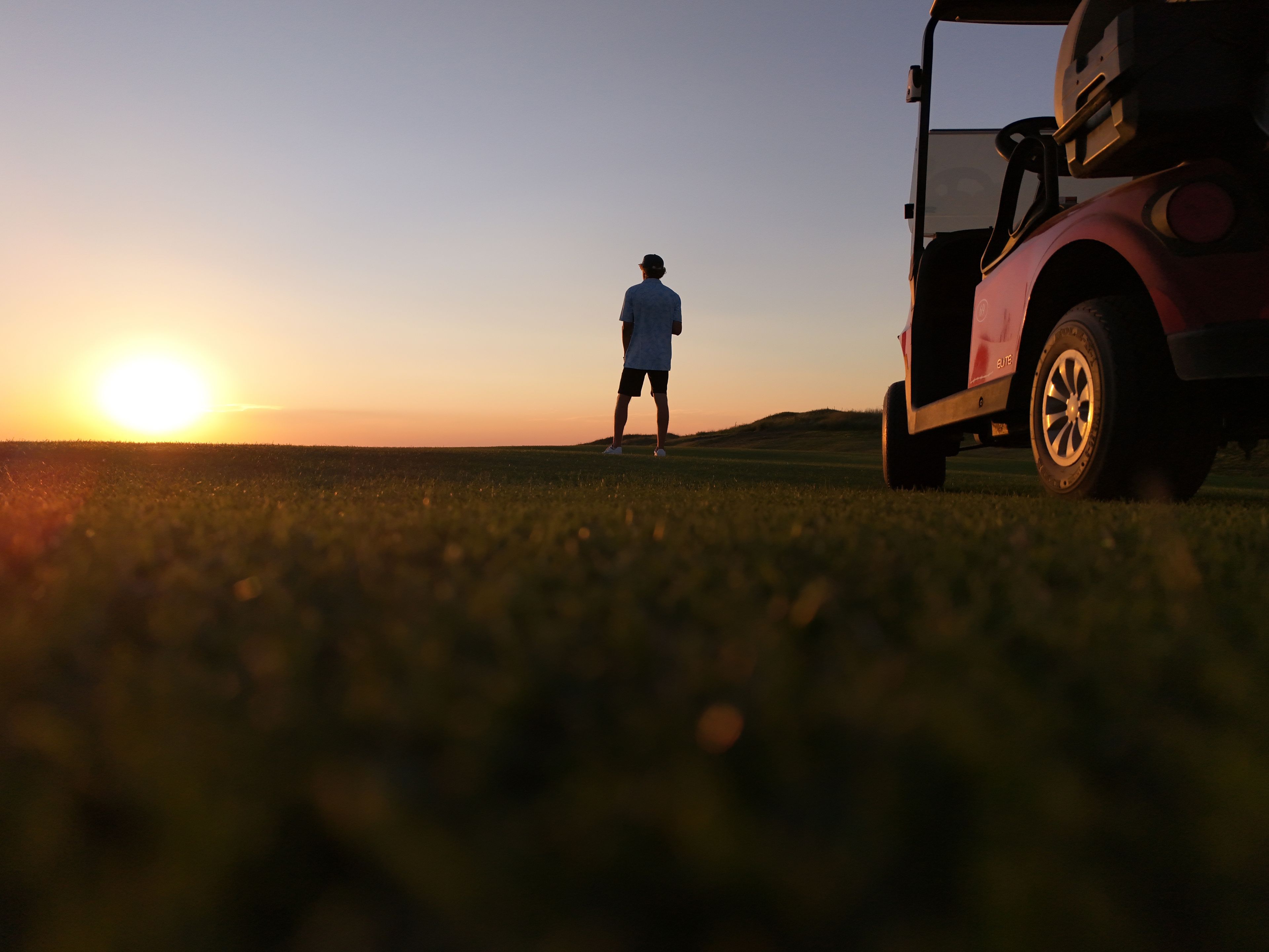 Golf concierge — sunset on the course with cart